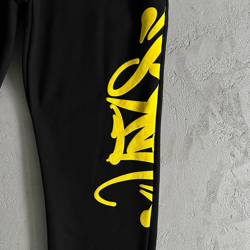 Conjunto Syna World Team Syna Jogger black/safety yellow