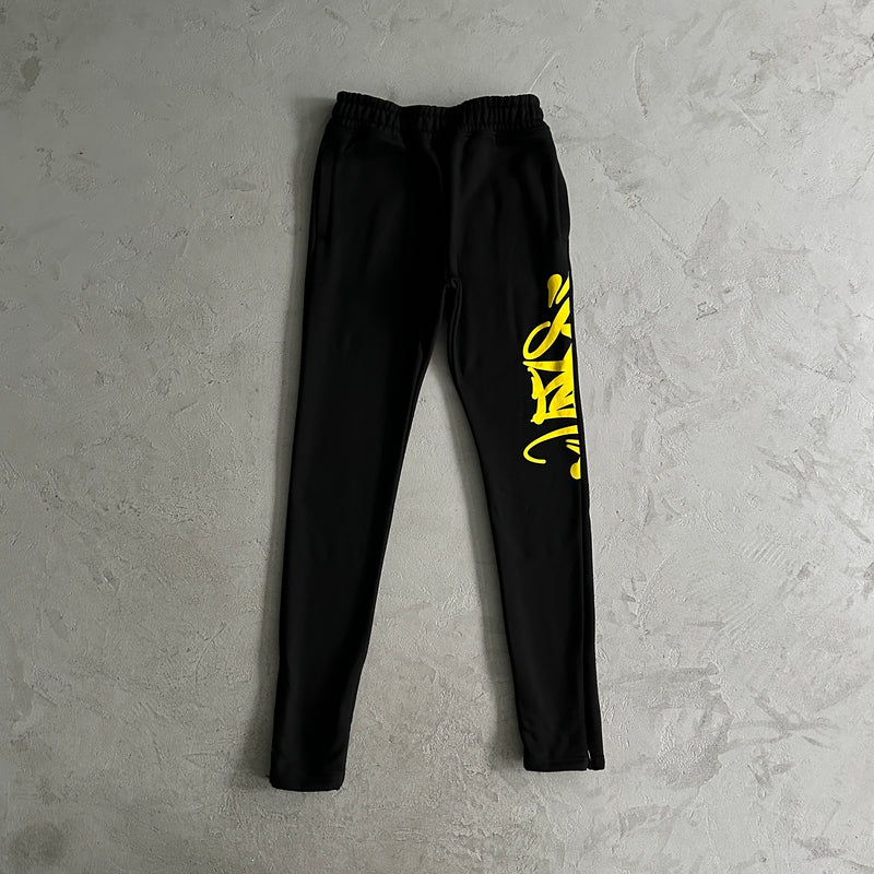 Conjunto Syna World Team Syna Jogger black/safety yellow